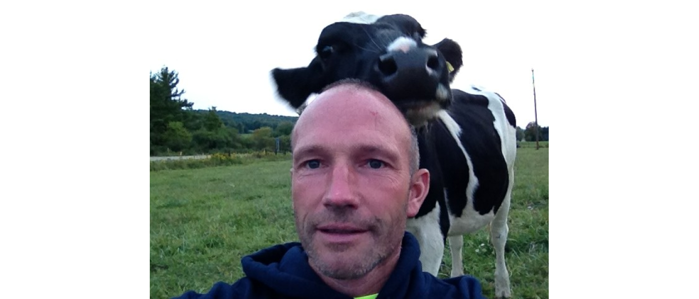 Chuck Deichmann in front of a cow