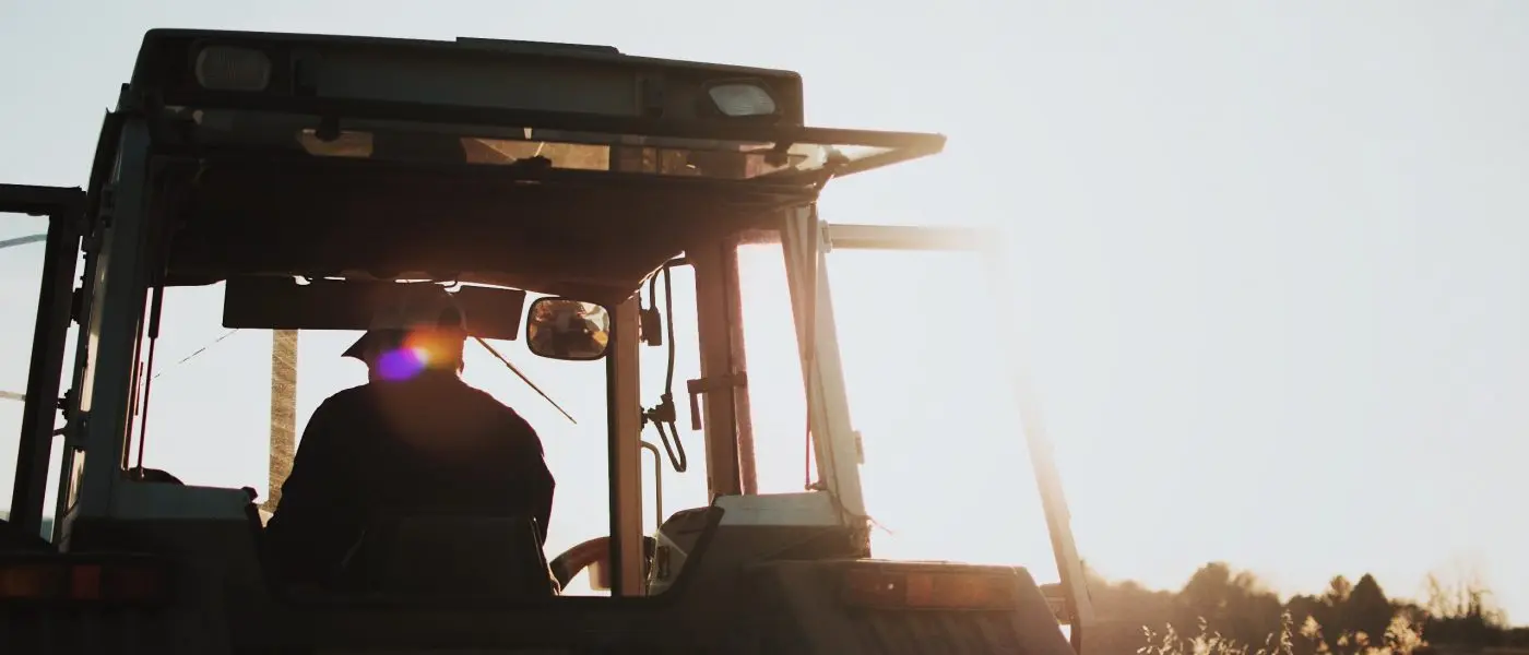 farmer in tractor from behind by spencer pugh