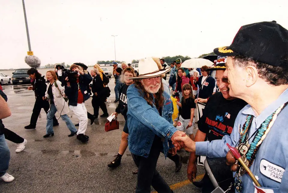 Willie Nelson shaking hands during a rally