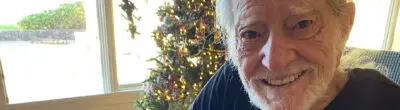Willie Nelson signing 2023 grant checks for Farm Aid