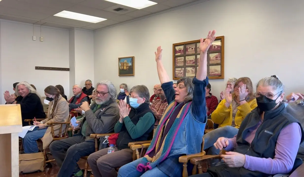 Community members sitting in meeting room