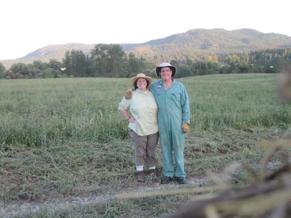 two people stand in front of a field
