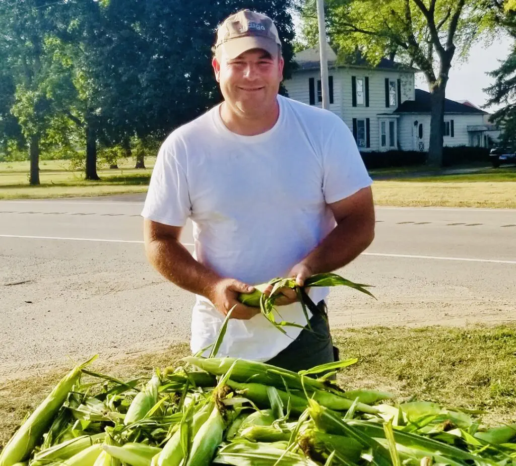 John Bartman selling sweet corn, an annual tradition in Marengo since 1964.