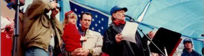 willie nelson and others stand on stage