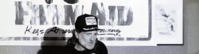 Willie Nelson speaking at a microphone