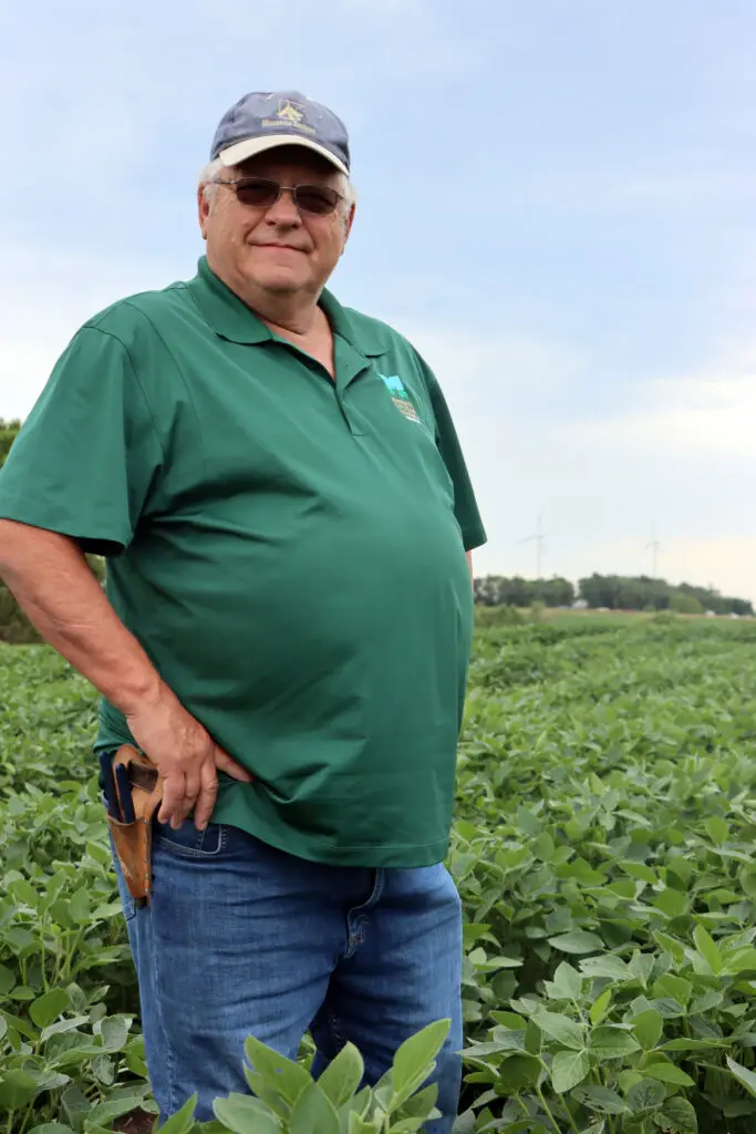 man standing in soybean field