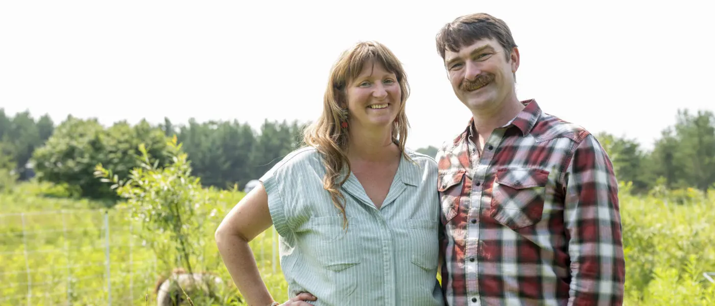 Farmers Emily and John Beaton stand in a field