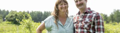 Farmers Emily and John Beaton stand in a field