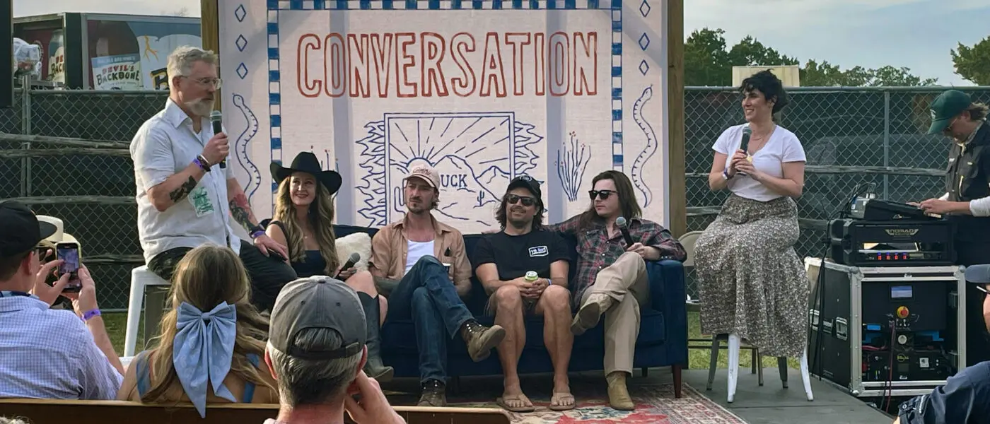 people on-stage for a "Community Conversation" recording a podcast