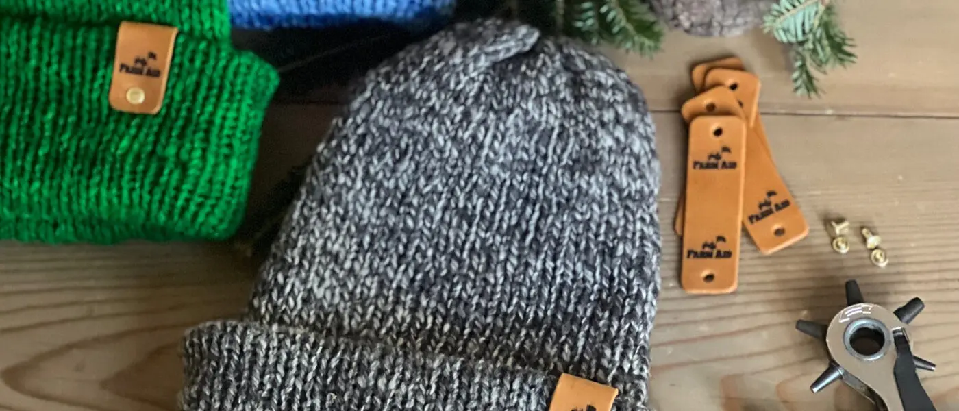 FARM AID wool hats on a table
