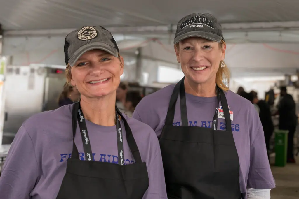 Two volunteers wearing aprons
