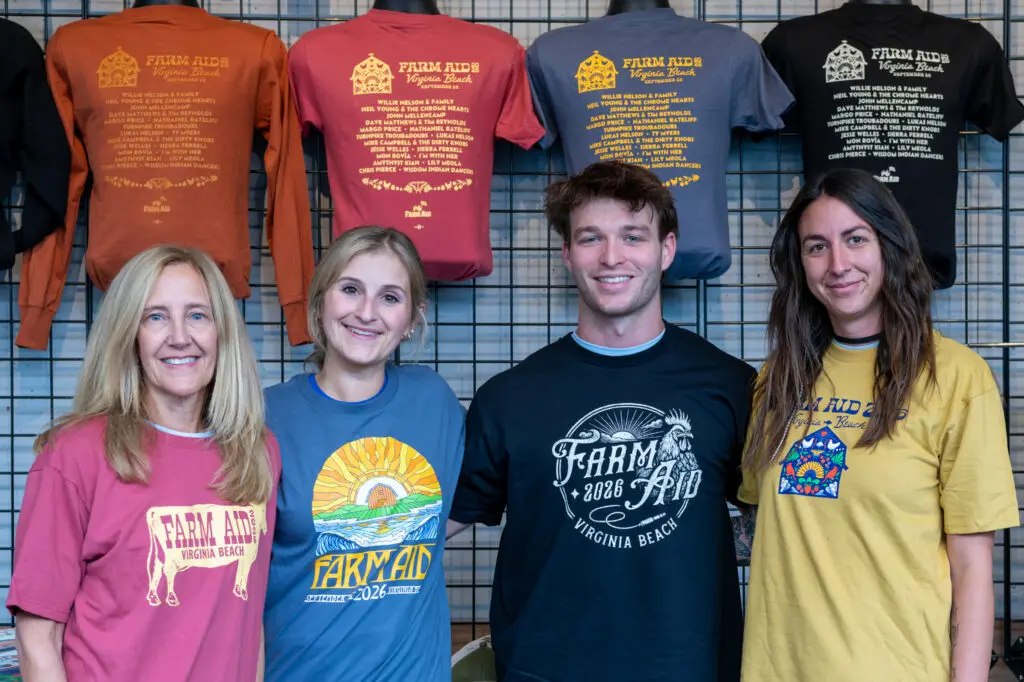 Four people wearing Farm Aid 2026 merch