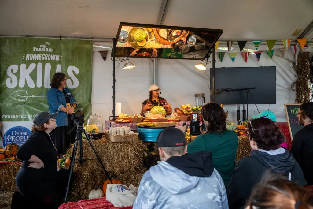 Salsa making demonstration with people sitting to watch