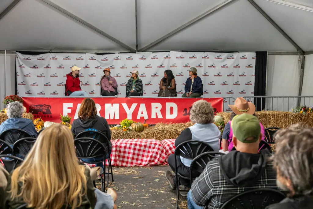 Five panelist speaking on the FarmYard stage