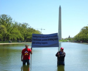 Wizipan Little Elk, of the Rosebud Sioux, and Art Tanderup risk arrest by standing in the Washington Monument Reflecting Pool in D.C. to protest TransCanada's proposed Keystone XL pipeline. (Photo by Garth Lenz / iLCP