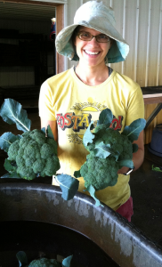 Laura washing farm fresh brocoli.