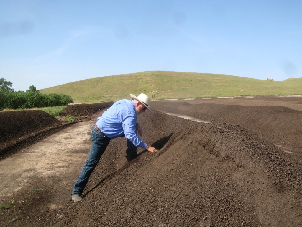 Ward Burroughs of Burroughs Family Farms, where they build compost from their organic dairy manure and almond orchard prunings, then apply it to the orchards for fertility.