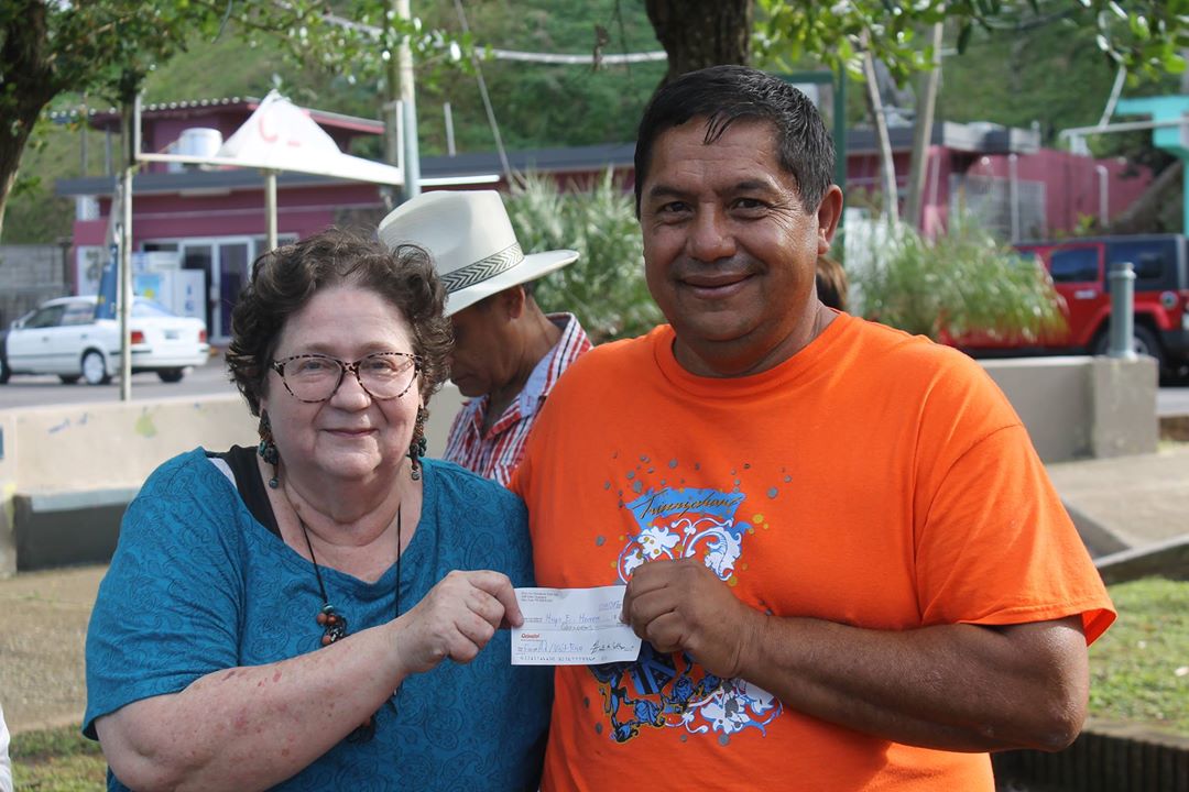 Hugo E. Herrera Mejía receives a check from Farm Aid. Photo: Visit Rico.