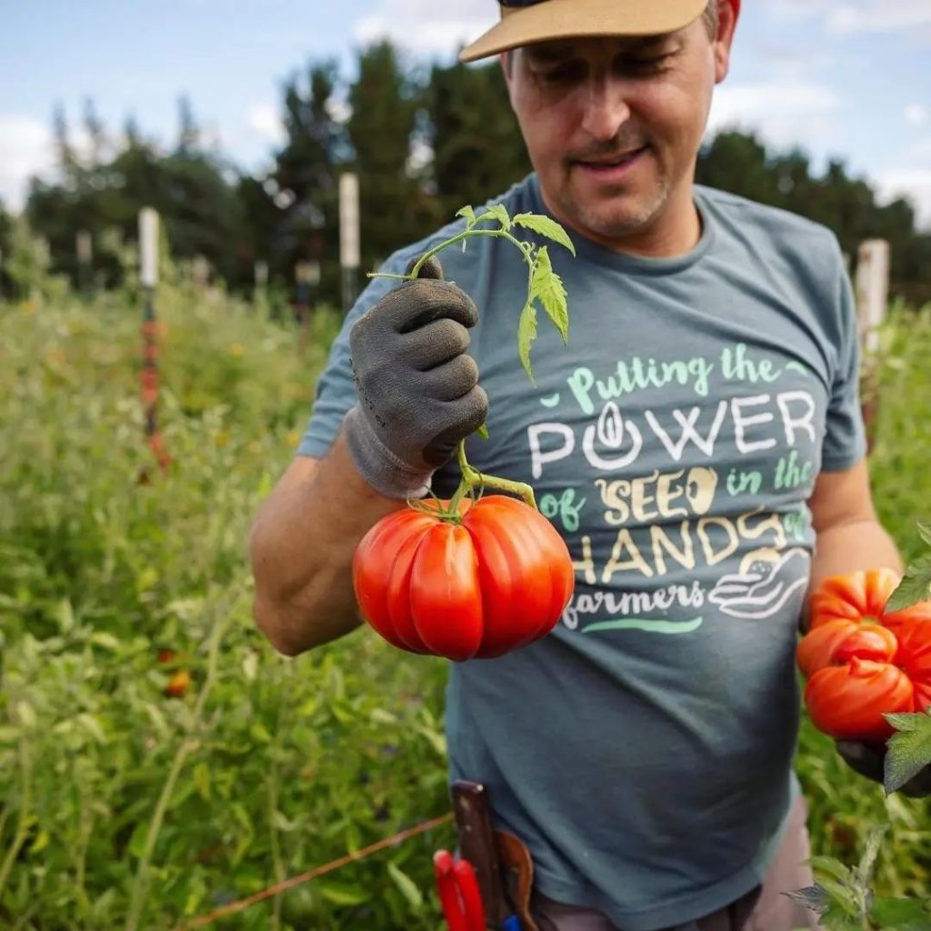 farmer Evan Gregoire holding tomatoes
