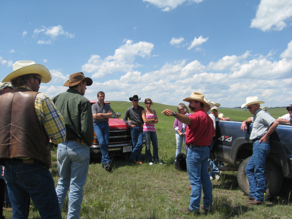 farmers and ranchers meeting in a field