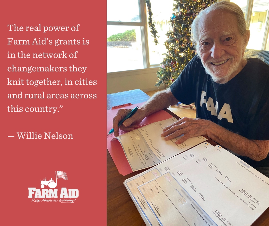 Willie Nelson signing checks to Farm Aid grantees with quote – The real power of Farm Aid’s grants is in the network of changemakers they knit together, in cities and rural areas across this country.” — Willie Nelson