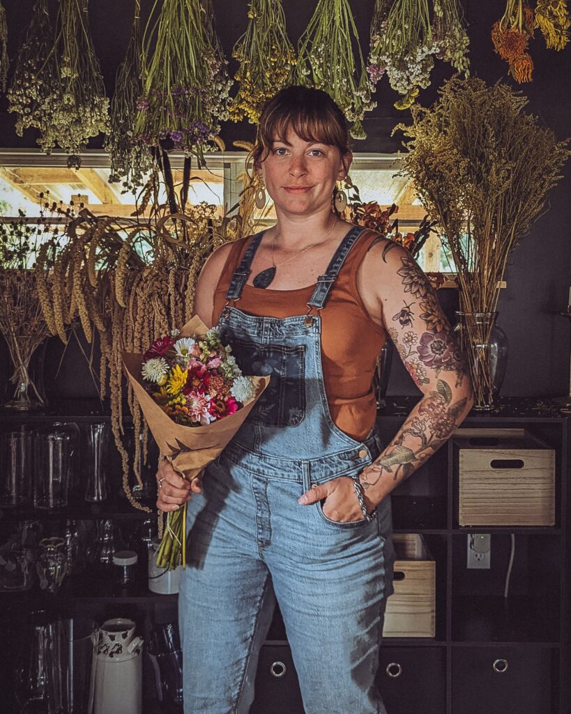 woman standing holding a bouquet of flowers