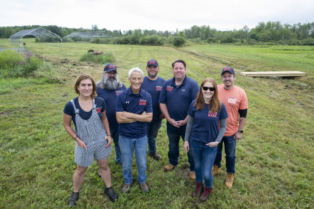 group of people posing for a photo on a farm