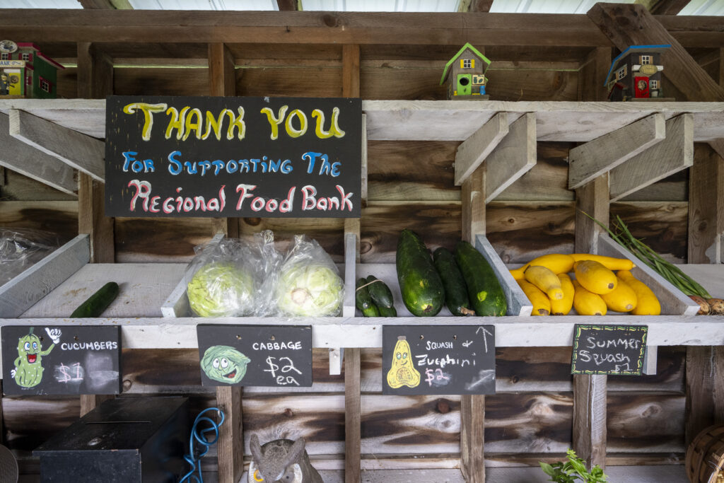 vegetable farm stand with sign that says THANK YOU FOR SUPPORTING THE REGIONAL FOOD BANK