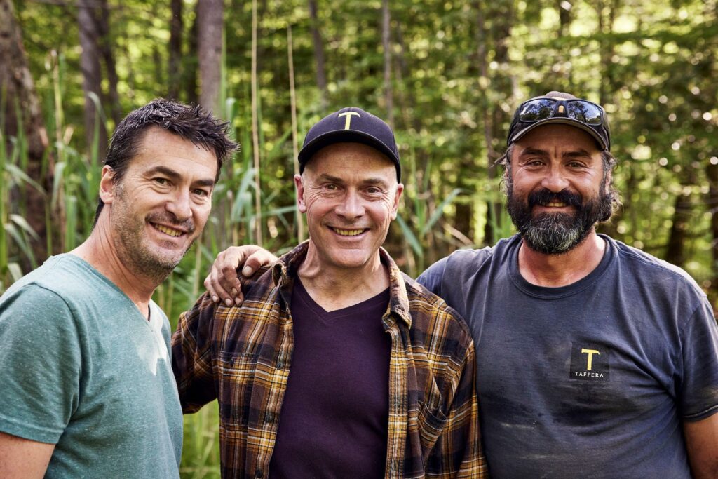 three men standing side by side