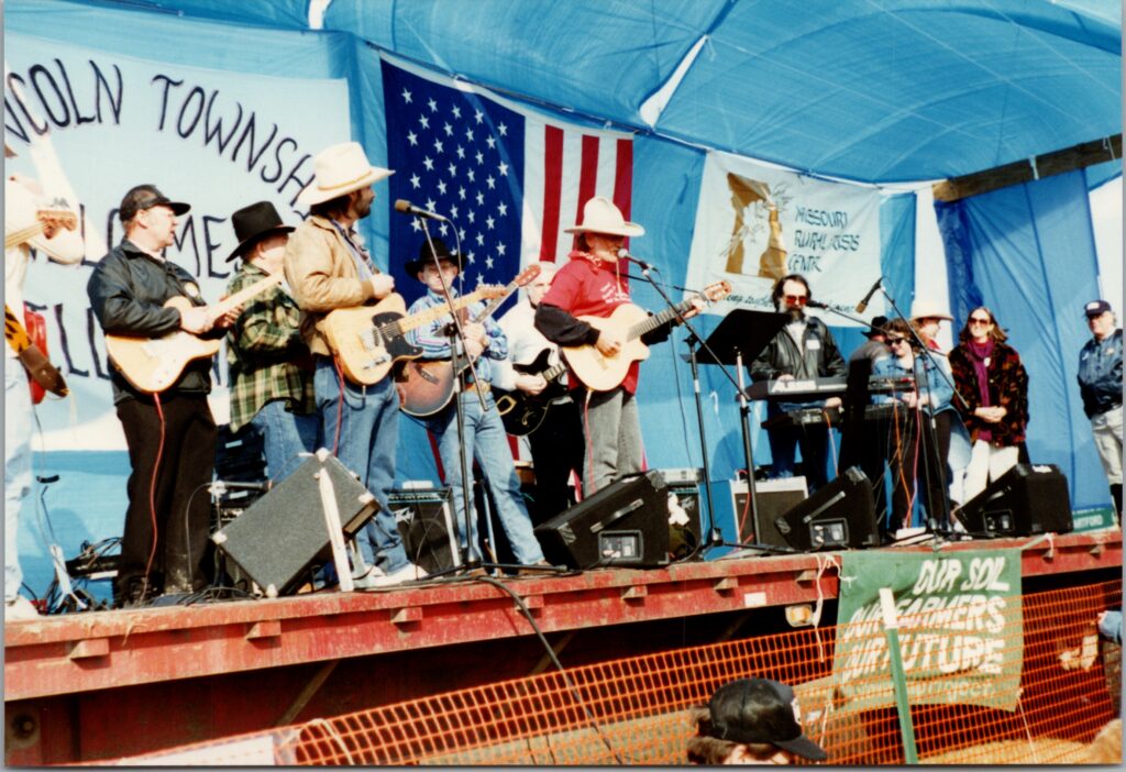 willie nelson on stage performing with a band