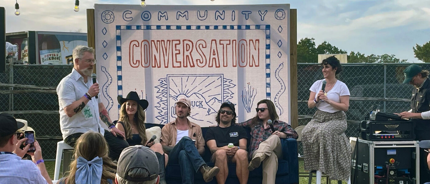 people on-stage for a "Community Conversation" recording a podcast